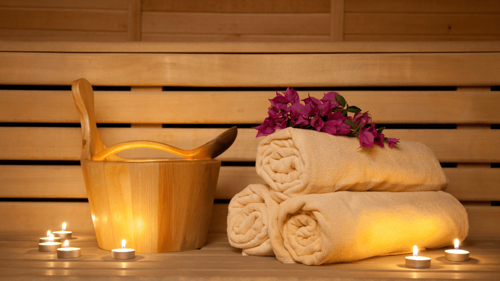 sauna bucket towels and accessories on a wooden bench
