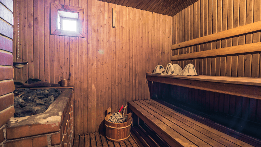 4 person sauna interior with stone heater and wooden benches 6kW vs 8kW sauna heater
