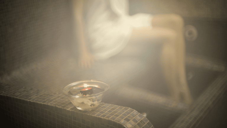Person relaxing in a steam room with visible steam ,steam rooms improve circulation