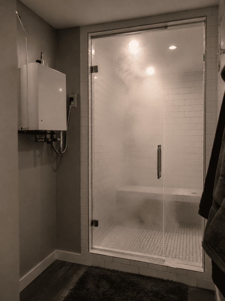 compact steam shower enclosure with tiled walls and remote generator cabinet