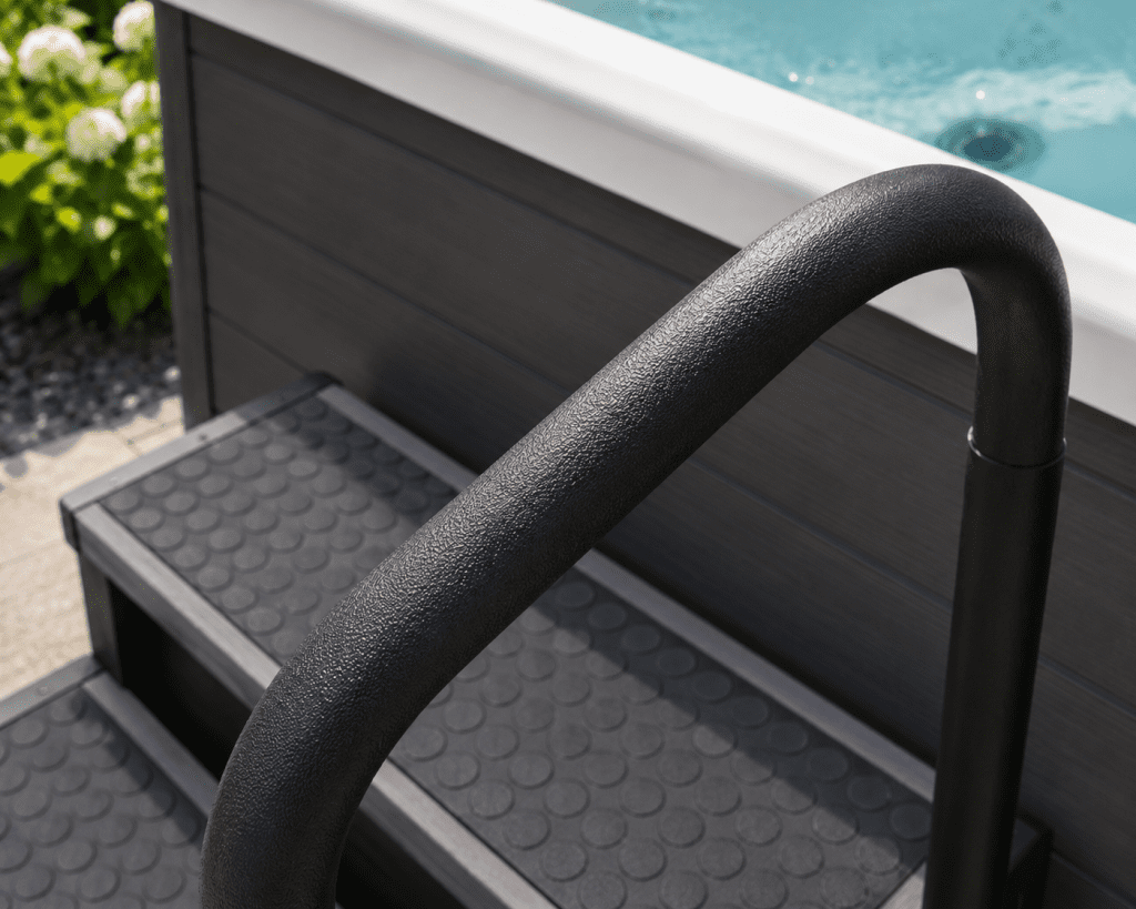 close-up of handrail grip on a hot tub entry step in an outdoor backyard setting