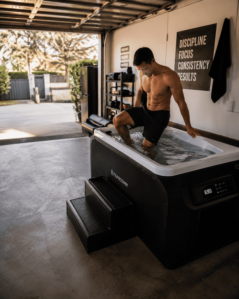 person stepping into a home ice plunge in a well-lit garage space ice plunge space requirements